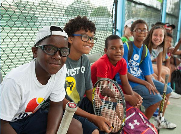 Young diverse tennis athletes looking at camera.