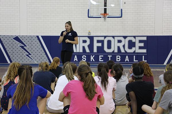 Kara Winger talking to young female basketball athletes.