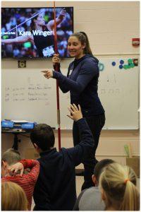 Kara Winger giving a presentation to elementary school children.