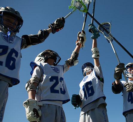 lacrosse players raising sticks