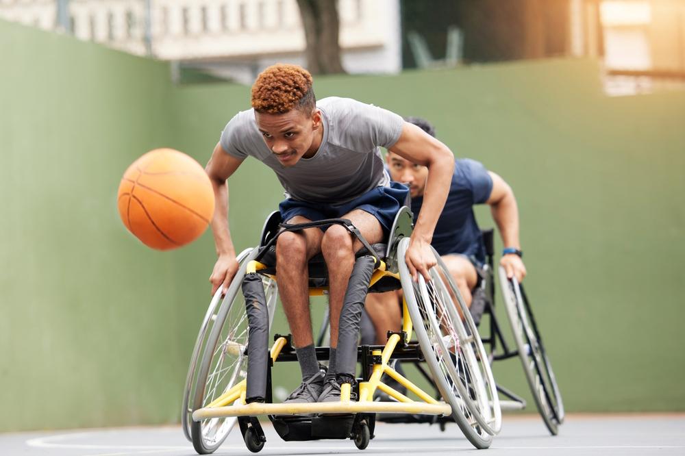 Two men playing wheelchair basketball.