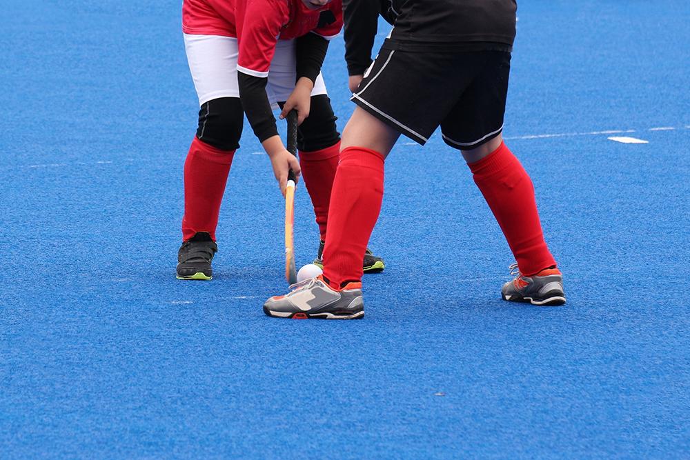Two field hockey players facing off.